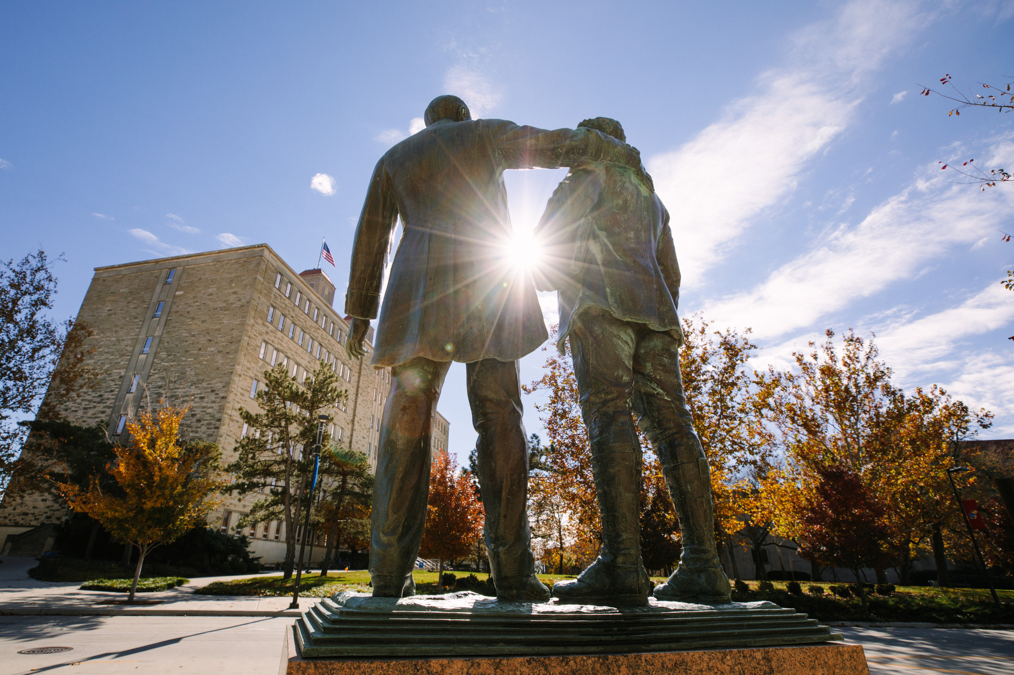 Outdoor sculpture of two men preparing for an embrace